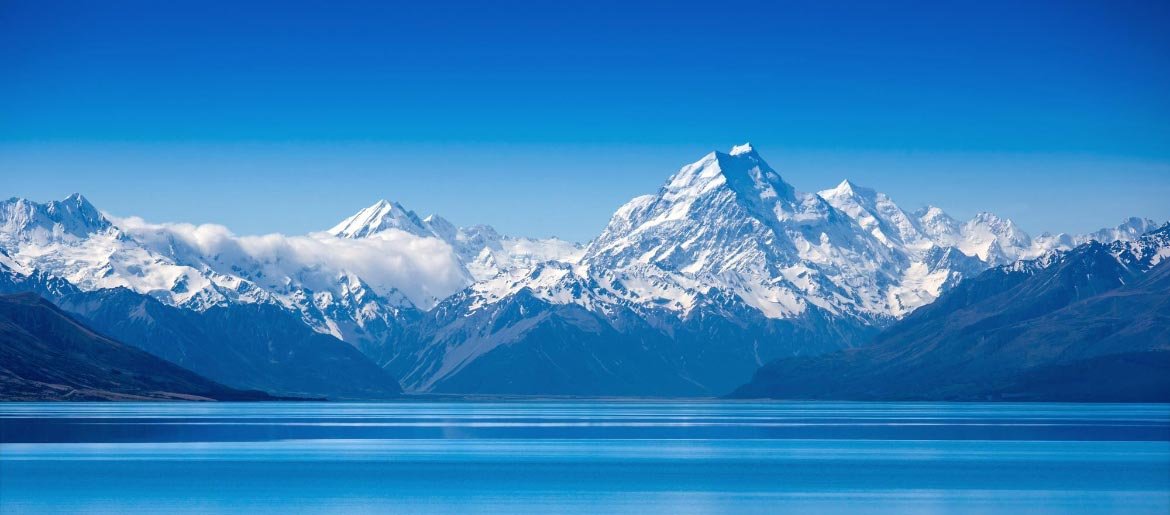 Snow on Mountains Across from Lake 2